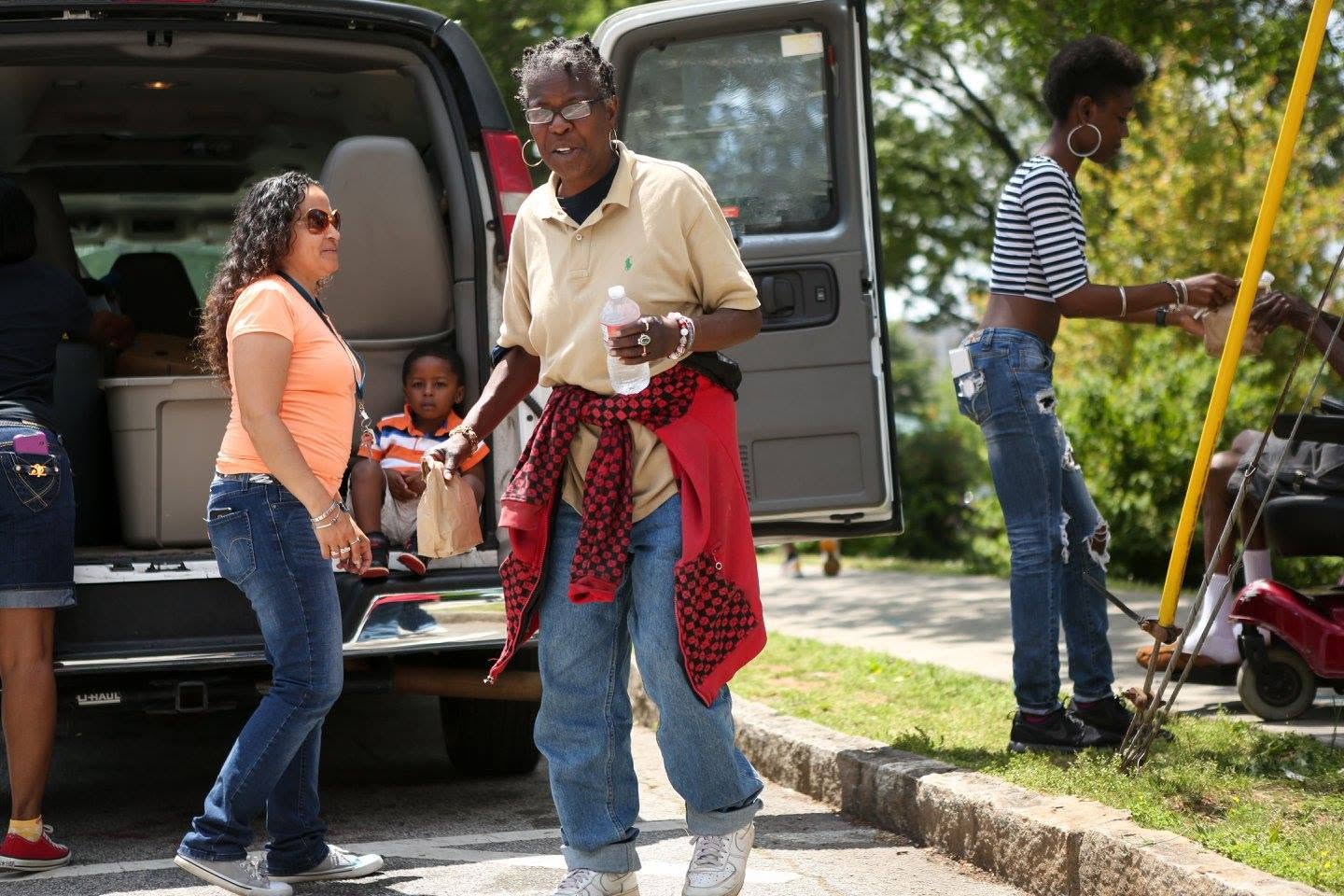 Volunteers distributing meals and water from an outreach van in Atlanta